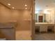 Bathroom with glass enclosed shower and tile flooring next to a large vanity at 6214 Crestview Se Dr, Covington, GA 30014