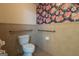 Small bathroom with toilet and handrail in decorative tiled room at 6214 Crestview Se Dr, Covington, GA 30014