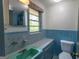 Bathroom featuring a window, tiling, sink, and toilet at 6214 Crestview Se Dr, Covington, GA 30014