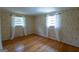 Cozy bedroom featuring hardwood floors, floral wallpaper, and natural light through the windows at 6214 Crestview Se Dr, Covington, GA 30014