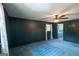 Large bedroom featuring a ceiling fan, a door to a bathroom, and dark blue walls at 6214 Crestview Se Dr, Covington, GA 30014