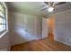 Bedroom with hardwood floors, a ceiling fan, double closets, and a doorway to another room at 6214 Crestview Se Dr, Covington, GA 30014