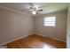 Bedroom featuring hardwood floors, a ceiling fan, and a window providing natural light at 6214 Crestview Se Dr, Covington, GA 30014