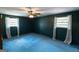 Spacious bedroom features a ceiling fan, two windows, and dark blue walls at 6214 Crestview Se Dr, Covington, GA 30014