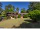 Traditional home showcasing its lush landscaping, brick exterior, and manicured lawn on a sunny day at 6214 Crestview Se Dr, Covington, GA 30014
