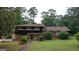 Traditional home featuring a combination brick and dark siding, enhanced by trimmed shrubs and a well-maintained lawn at 6214 Crestview Se Dr, Covington, GA 30014