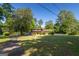 Landscaped home with mature trees, manicured lawn, and classic brickwork enhancing its curb appeal at 6214 Crestview Se Dr, Covington, GA 30014