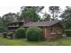 A charming brick home with mature landscaping, lush green lawn, and a cozy residential feel at 6214 Crestview Se Dr, Covington, GA 30014