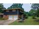Charming two-story home with a brick and dark wood exterior, complemented by a well-manicured lawn at 6214 Crestview Se Dr, Covington, GA 30014