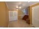 Foyer showing tile flooring, a staircase, and neutral-toned walls with door leading to closet or pantry at 6214 Crestview Se Dr, Covington, GA 30014