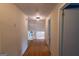 Upstairs hallway view features hardwood floors, neutral walls, and a peek at the home's stairway at 6214 Crestview Se Dr, Covington, GA 30014