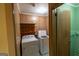 Laundry room with washer and dryer, wood-paneled walls, and orange shelving at 6214 Crestview Se Dr, Covington, GA 30014