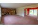 Open-concept living area with brick fireplace, stairs, and sliding door access at 6214 Crestview Se Dr, Covington, GA 30014