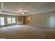 Open living room with tray ceiling, ceiling fan, and backyard access at 6214 Crestview Se Dr, Covington, GA 30014