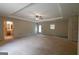 Large living room with tray ceiling, ceiling fan, and doorway access at 6214 Crestview Se Dr, Covington, GA 30014