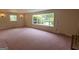 Bright living room featuring large windows, carpet floors, and ample space at 6214 Crestview Se Dr, Covington, GA 30014