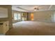 Spacious living room with bright windows, neutral carpet, and built in cabinets at 6214 Crestview Se Dr, Covington, GA 30014