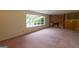 Spacious living room with a brick fireplace and large window overlooking the yard at 6214 Crestview Se Dr, Covington, GA 30014