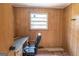 Office features wood-paneled walls, a window, desk, and executive chair at 6214 Crestview Se Dr, Covington, GA 30014
