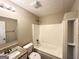 Cozy bathroom with granite-style countertops, a tiled shower, and new toilet at 9124 Comstock Ct, Covington, GA 30014
