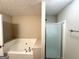 Bathroom featuring a garden tub with jets, a glass-enclosed shower, and neutral wall color at 9124 Comstock Ct, Covington, GA 30014