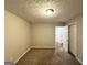 Bedroom featuring neutral walls, plush carpeting, a window, and an adjacent walk-in closet and bath at 9124 Comstock Ct, Covington, GA 30014