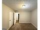 Bedroom featuring neutral walls, plush carpeting, and an adjacent walk-in closet at 9124 Comstock Ct, Covington, GA 30014