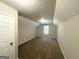 Bonus room featuring neutral paint, carpet flooring, and a door at 9124 Comstock Ct, Covington, GA 30014