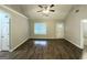 Spacious living room featuring wood-look vinyl flooring, large windows, high ceilings, and a ceiling fan at 9124 Comstock Ct, Covington, GA 30014