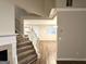 An open living room with a staircase, seamlessly connecting to the dining area through a bright doorway at 9124 Comstock Ct, Covington, GA 30014