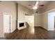 Inviting living room with a fireplace, high ceilings, wood-look vinyl flooring, and staircase access to the second floor at 9124 Comstock Ct, Covington, GA 30014