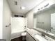 Bathroom showcasing a shower-tub combo, granite countertop, and updated fixtures at 408 Kendall Ln, Mcdonough, GA 30253