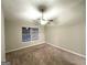 Neutral bedroom with ceiling fan, window with blinds, and plush carpeting at 408 Kendall Ln, Mcdonough, GA 30253