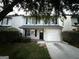 Charming two-story home with a one-car garage, manicured lawn, and freshly painted light gray siding at 408 Kendall Ln, Mcdonough, GA 30253