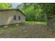 The backyard of a single-story home is surrounded by trees and lush greenery, offering a private retreat at 525 Baker Nw Cir, Atlanta, GA 30318
