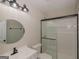 Bright bathroom features a new vanity, shower, and a round mirror at 525 Baker Nw Cir, Atlanta, GA 30318