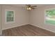 Bedroom features wood-look flooring, ceiling fan, and two windows at 525 Baker Nw Cir, Atlanta, GA 30318