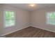 Bright bedroom features wood-look flooring and two large windows at 525 Baker Nw Cir, Atlanta, GA 30318