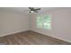 Bedroom features wood-look flooring, ceiling fan, and backyard view at 525 Baker Nw Cir, Atlanta, GA 30318