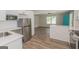 Bright kitchen with stainless steel appliances, white cabinetry and countertops, and wood-look flooring at 525 Baker Nw Cir, Atlanta, GA 30318