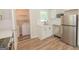 Well-lit kitchen with stainless steel appliances, white cabinets and countertops, and a laundry area at 525 Baker Nw Cir, Atlanta, GA 30318