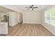 Open-concept living area featuring wood-look floors, a ceiling fan, and bright natural light at 525 Baker Nw Cir, Atlanta, GA 30318