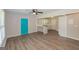 Open-concept living room with wood-look flooring and a teal front door at 525 Baker Nw Cir, Atlanta, GA 30318