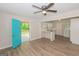 Light-filled living space with wood-look flooring, ceiling fan, and easy access to the kitchen and deck at 525 Baker Nw Cir, Atlanta, GA 30318