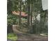 Wooded home exterior with lush trees, set back from the road, and an American flag at 8636 Woodside Ln, Jonesboro, GA 30238