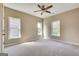Bright bedroom featuring neutral walls, ceiling fan, and large windows providing ample natural light at 3641 Ridge Towne Dr, Duluth, GA 30096