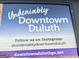 A sign promoting Downtown Duluth with its website and Instagram handle at 3641 Ridge Towne Dr, Duluth, GA 30096