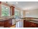 Kitchen view featuring dark wood cabinets, stainless appliances, and outdoor view at 3641 Ridge Towne Dr, Duluth, GA 30096