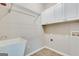 Functional laundry room with a utility sink, cabinetry, and tile flooring for added convenience at 3641 Ridge Towne Dr, Duluth, GA 30096