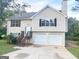 Charming two-story home with a two-car garage and a well-maintained front yard at 4411 Ward Bluff Ct, Ellenwood, GA 30294